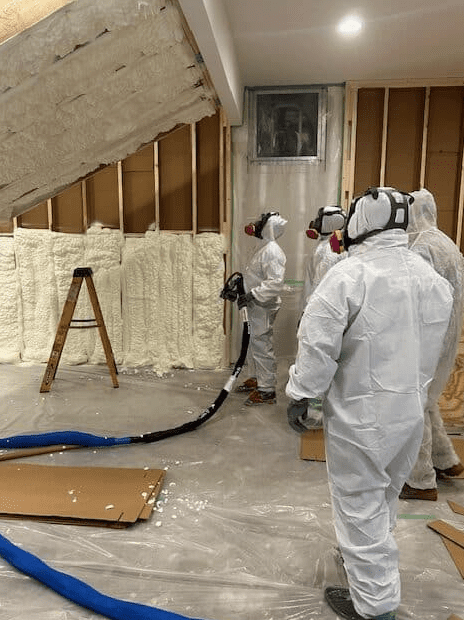 spray foam insulating studs and spray foaming cathedral roof deck training mock up room
