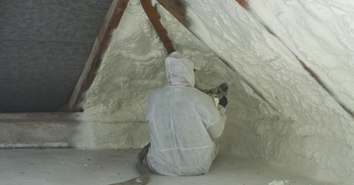 Spray polyurethane foam is applied to a roof surface, creating a seamless insulation layer for weather protection.